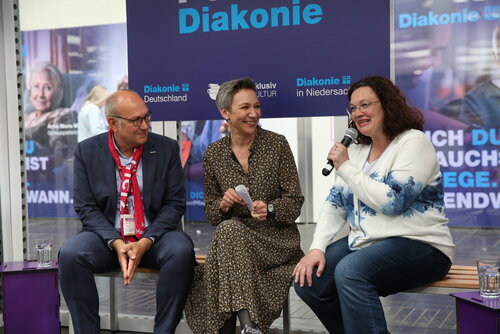 Rüdiger Schuch, Christina von Saß und Andrea Nahles beim Talk am Stand der Diakonie in Niedersachsen